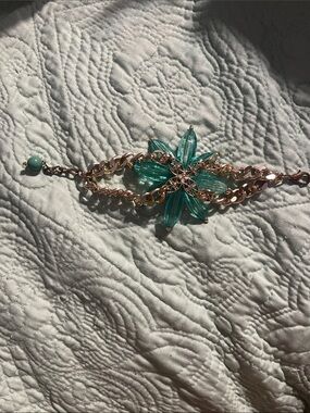 Gold color chained bracelet with green beads and porcelain flower
